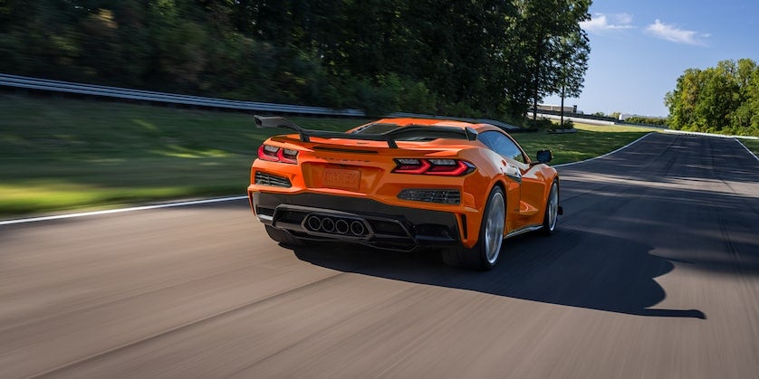 Orange Corvette driving on racetrack