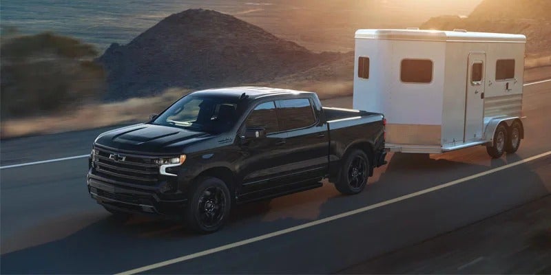 2026 Chevrolet Silverado 1500 Crew Cab towing a travel trailer