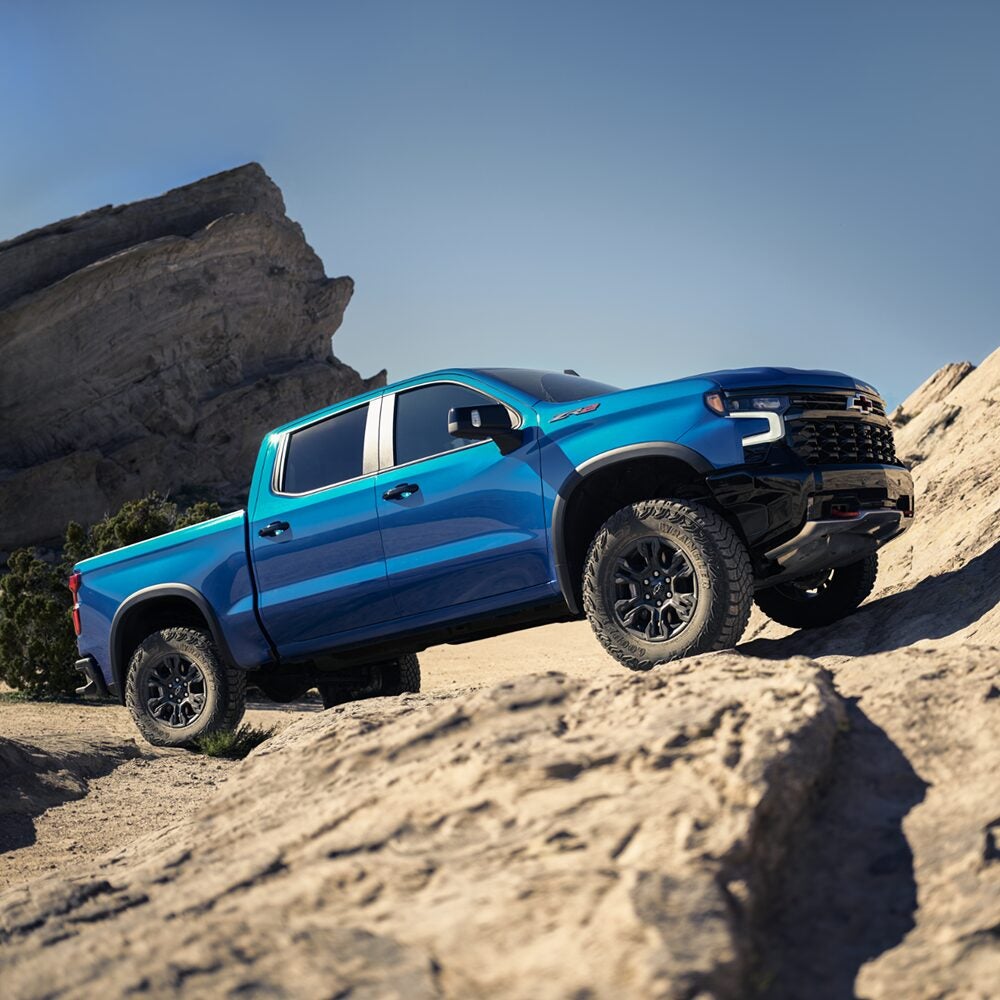 2026 Chevrolet Silverado ZR2 driving over rocky off-road terrain